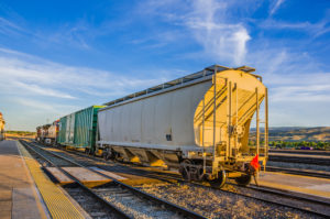 freight train on tracks with blue sky in the background
